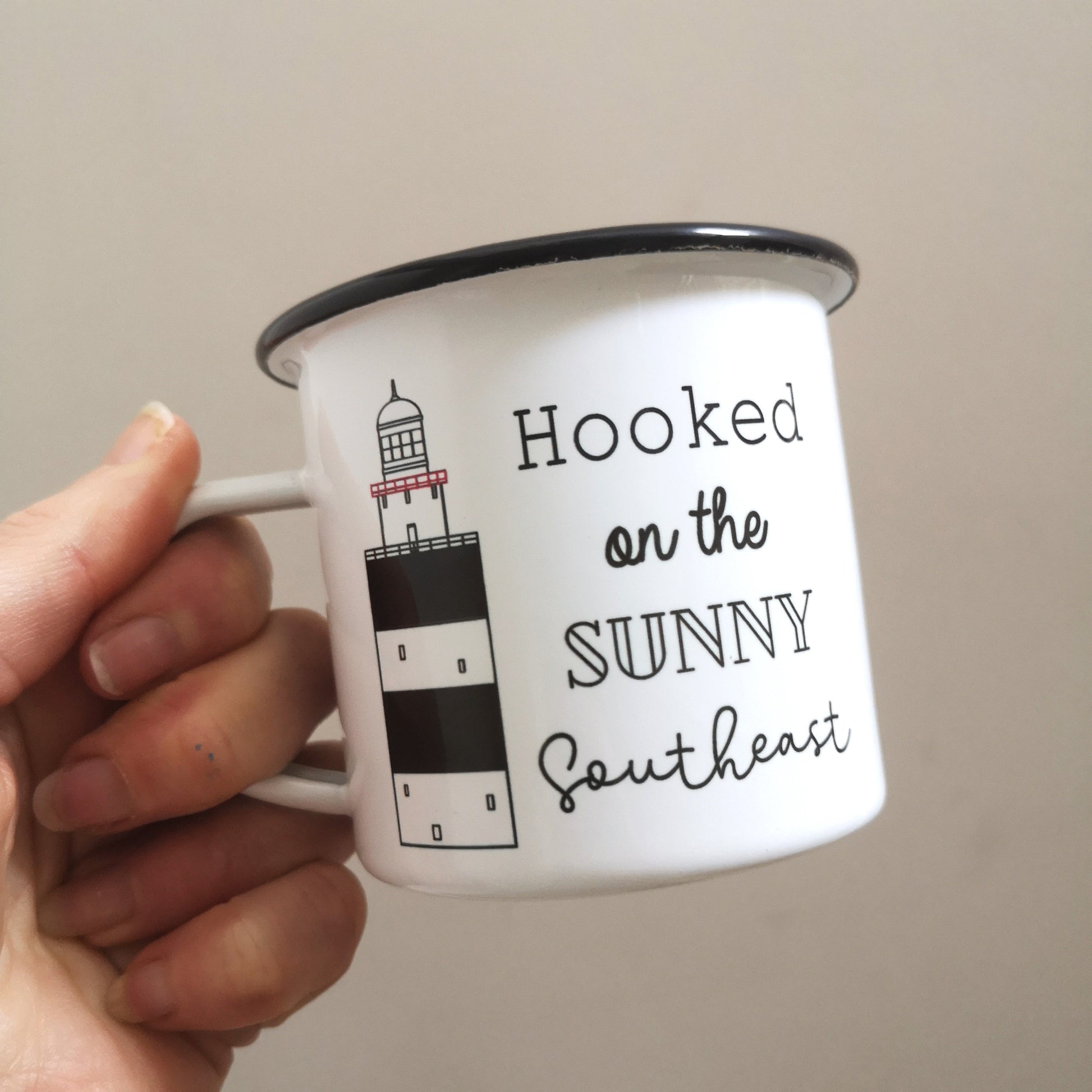 Hooked on the Sunny Southeast enamel mug, with a drawing of the infamous Hook Head lighthouse on it