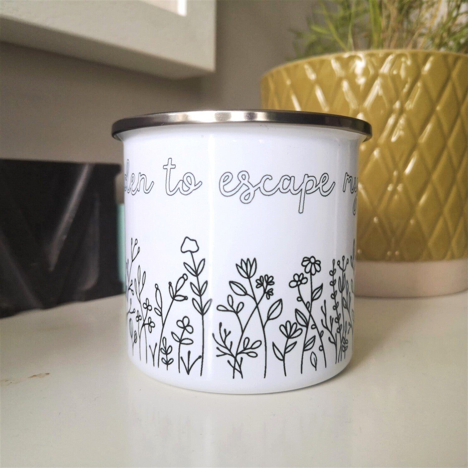I only Garden to escape My Family enamel mug with black rim, flower border below the text, side view