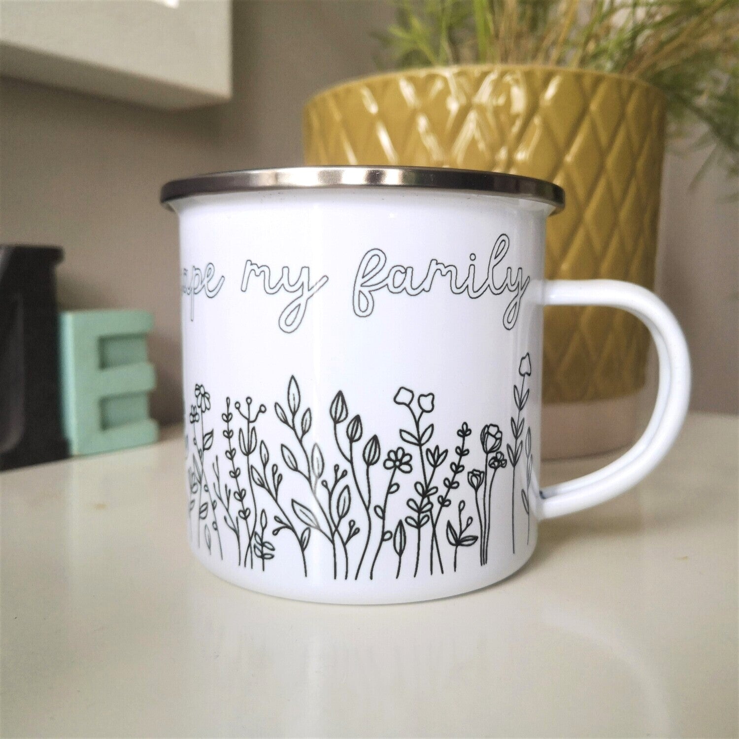 I only Garden to escape My Family enamel mug with black rim, flower border below the text, back view